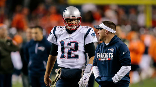 Nov 12, 2017; Denver, CO, USA; New England Patriots quarterback Tom Brady (12) talks with assistant quarterbacks coach Jerry Schuplinski before the game against the Denver Broncos at Sports Authority Field at Mile High.